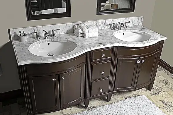 Dark wooden double sink bathroom vanity with curved edges and a marble countertop.
